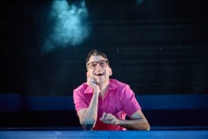 Ryan J. Haddad wears a bright pink shirt in his solo play "Hold Me in the Water."