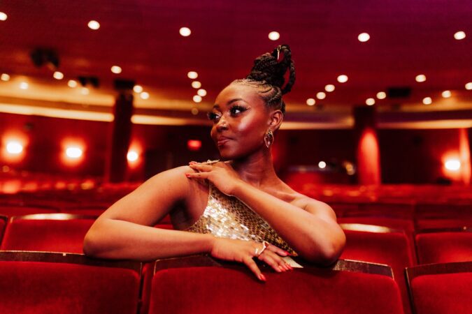 Broadway star Aisha Jackson sits in a theater
