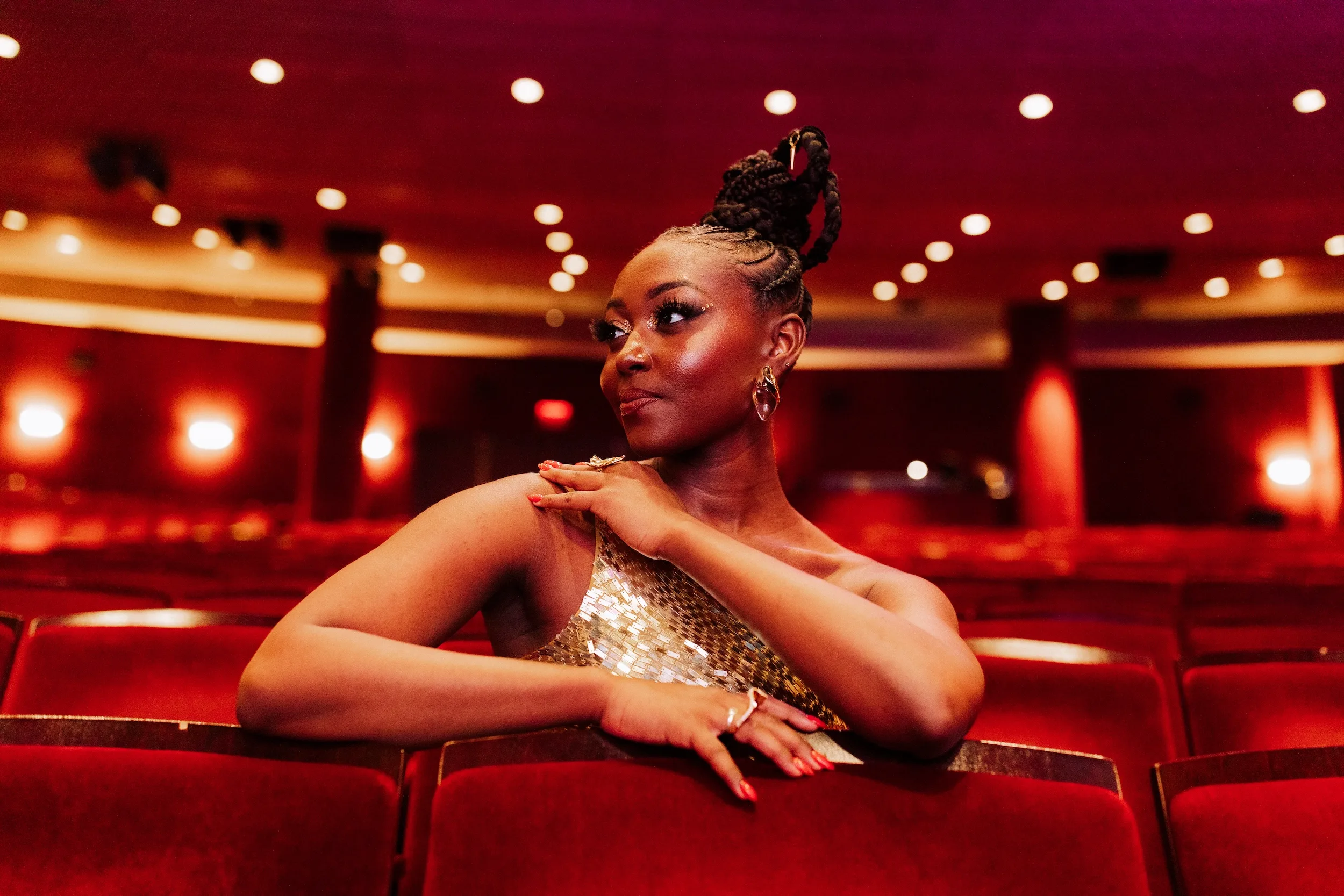 Broadway star Aisha Jackson sits in a theater