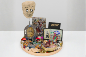 Agosto Machado, Downtown (Altar), 2024. Pins, matchbooks, mirror, and papier-mâché; plastic and metal objects; book (Theater of the Ridiculous), photograph, jewelry, bananaflavored straw packets, New York City subway tokens; and original artworks by Arch Connelly, Thomas Lanigan-Schmidt, and Gilda Pervin. Collection of Jane Hait. © Agosto Machado. Image courtesy the artist and Gordon Robichaux, NY. Photography by Greg Carideo