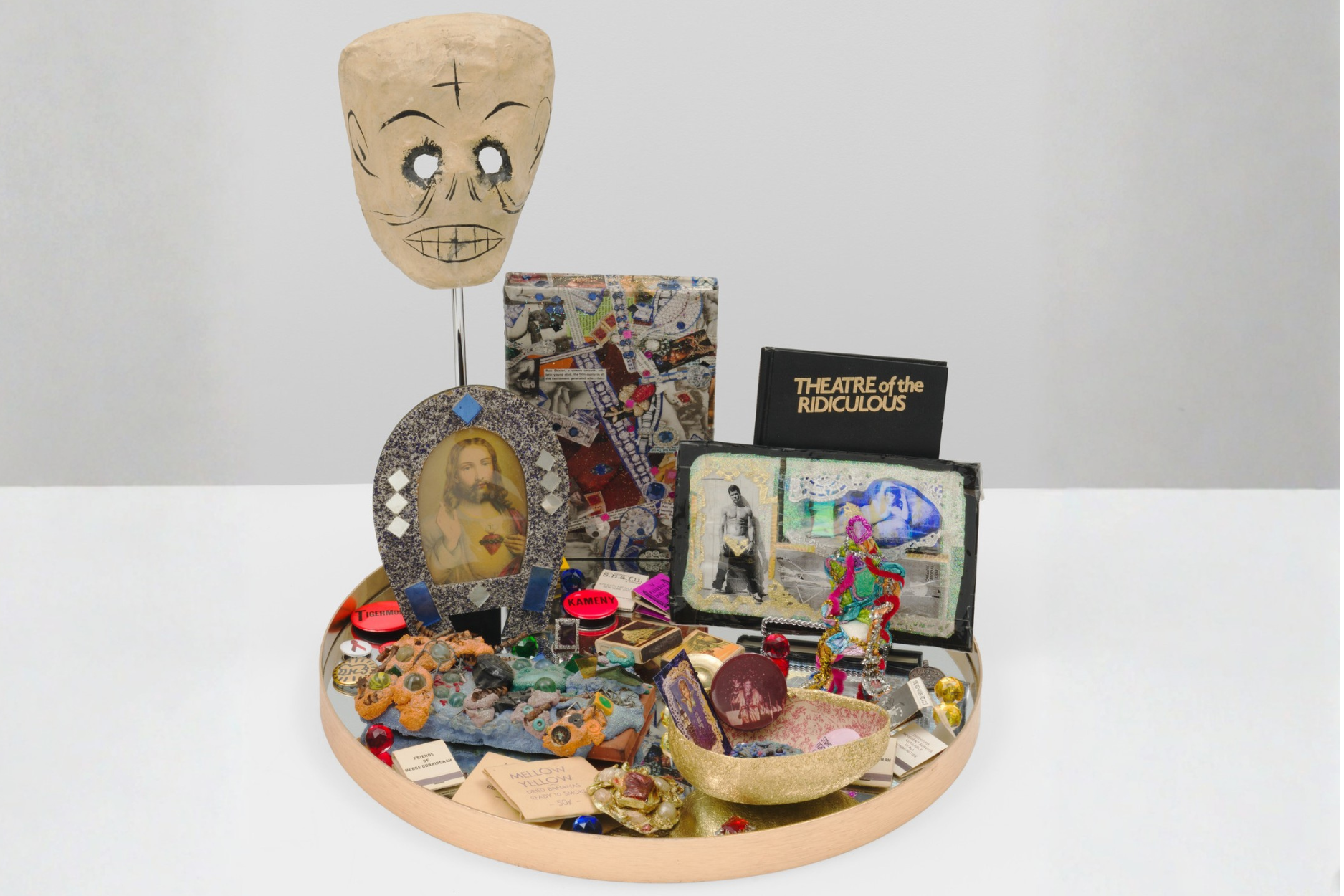 Agosto Machado, Downtown (Altar), 2024. Pins, matchbooks, mirror, and papier-mâché; plastic and metal objects; book (Theater of the Ridiculous), photograph, jewelry, bananaflavored straw packets, New York City subway tokens; and original artworks by Arch Connelly, Thomas Lanigan-Schmidt, and Gilda Pervin. Collection of Jane Hait. © Agosto Machado. Image courtesy the artist and Gordon Robichaux, NY. Photography by Greg Carideo