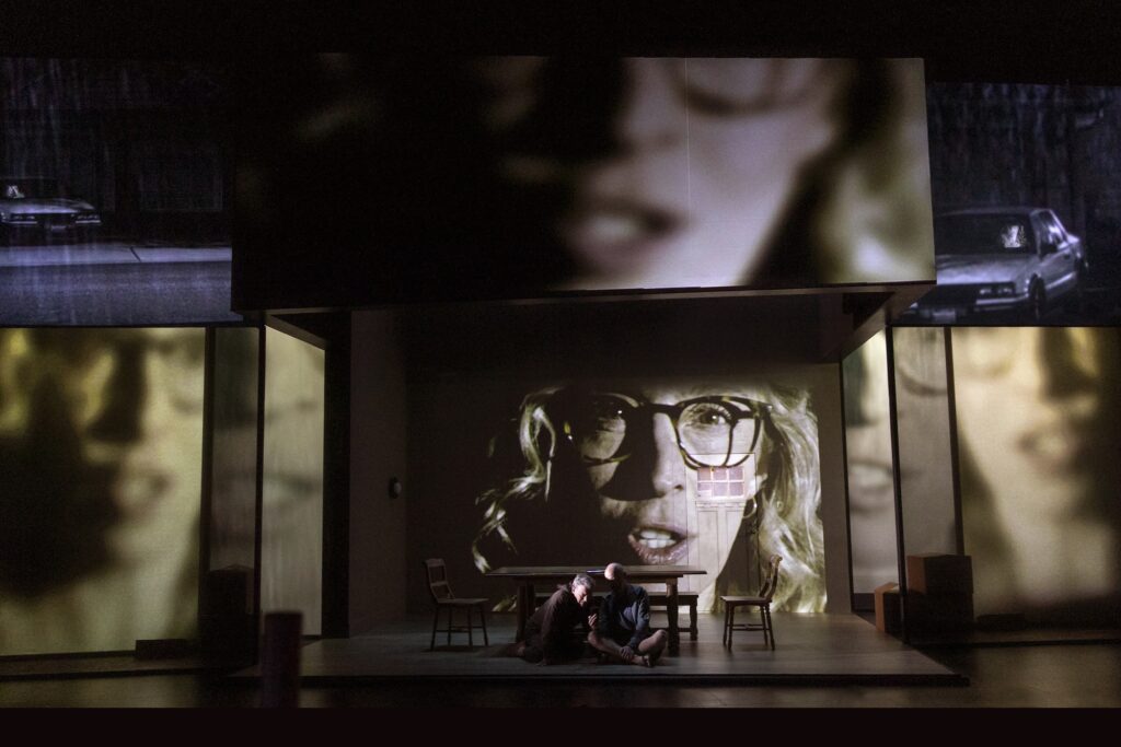 Jeremy Shamos, Jeff Biehl, and Crystal Finn (on screen) in "ANON."